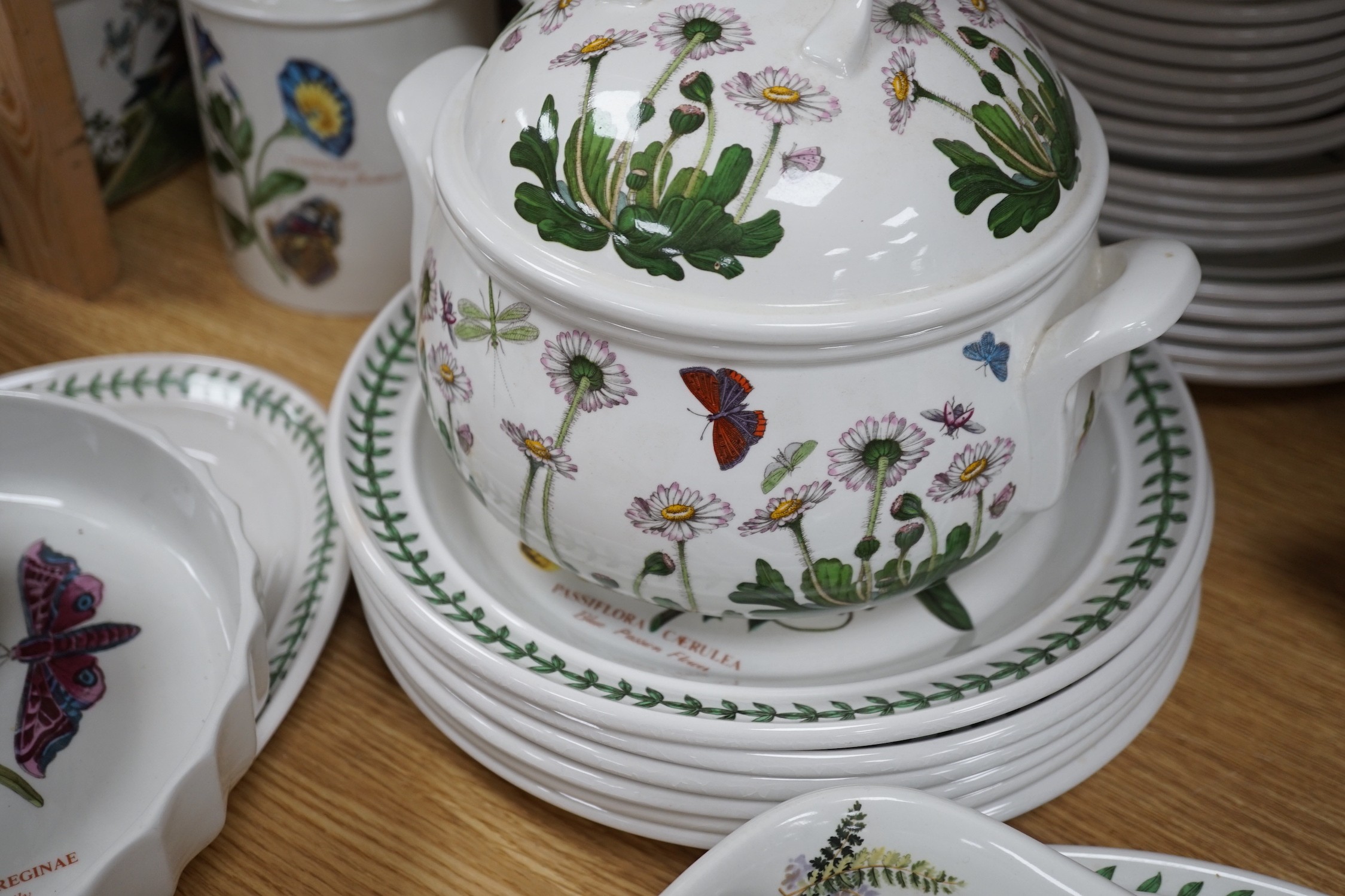 A mixed Portmerion dinner service- a biscuit jar and cover, tureens, serving dishes, teapot etc